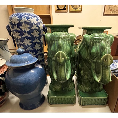 1057 - A pair of green glazed stands, in the form of elephants, 56 cm high, a blue and white vase, 65 cm hi... 