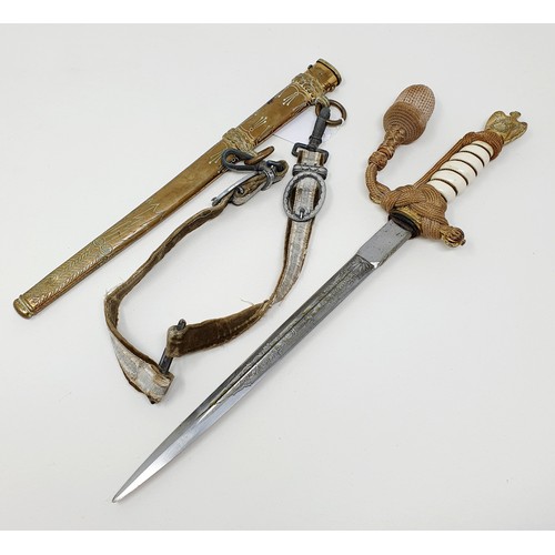 600 - A German World War II dagger, with a scabbard and hanger, 42 cm