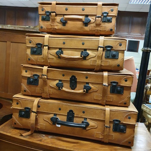 714 - A set of four graduated Giovanni suitcases, the largest 79 cm wide