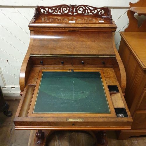 862 - A 19th century piano top walnut Davenport, the interior fitted with various compartments and inset a... 