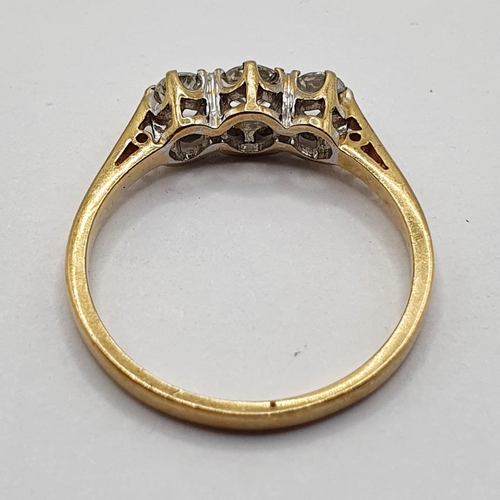 164 - A 9ct gold and three stone diamond ring, ring size L