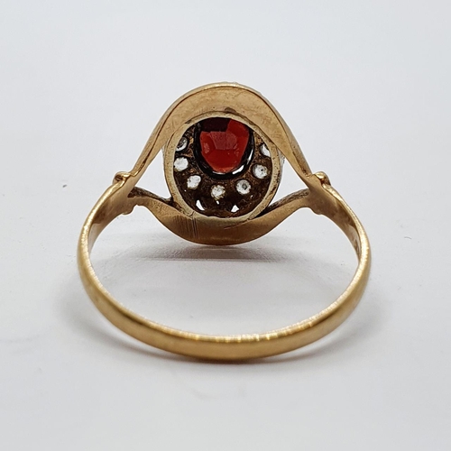 29 - A 9ct gold and garnet set cluster ring, ring size T 1/2...