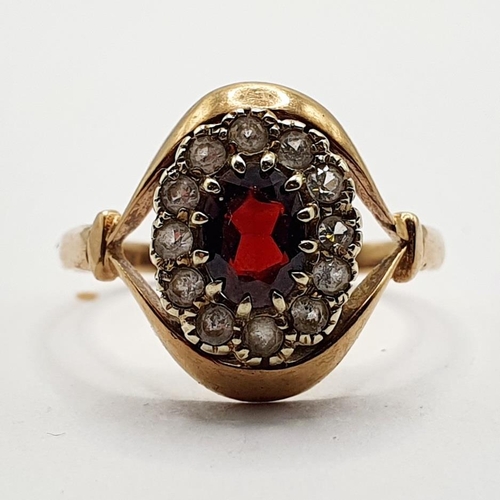 29 - A 9ct gold and garnet set cluster ring, ring size T 1/2...