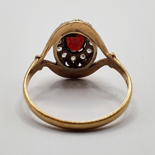 29 - A 9ct gold and garnet set cluster ring, ring size T 1/2...