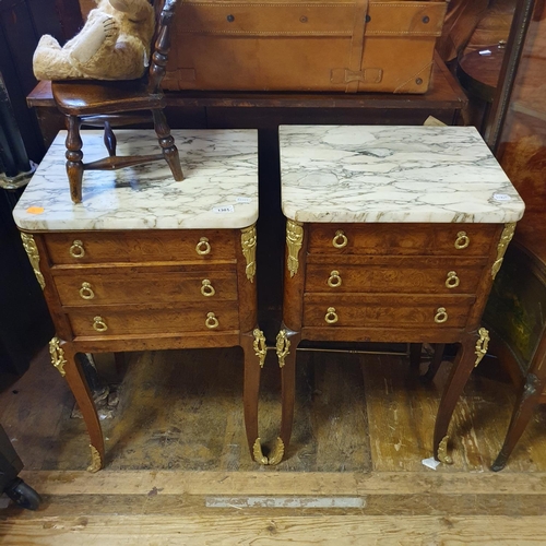 880 - A pair of French inlaid walnut bedside chests, having a marble top above three drawers, on cabriole ... 