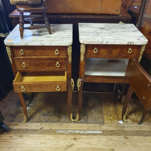 880 - A pair of French inlaid walnut bedside chests, having a marble top above three drawers, on cabriole ... 