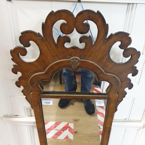 872 - A walnut framed mirror, with scroll decoration