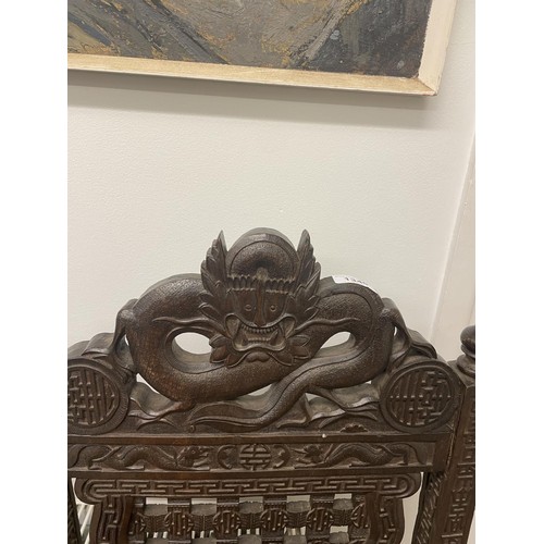 929 - A pair of Burmese carved armchairs, decorated dragons (2)