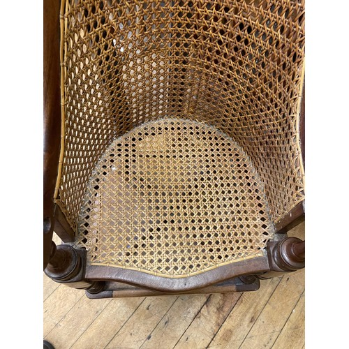 992 - An early 19th century mahogany childs bergere high chair, on a stand