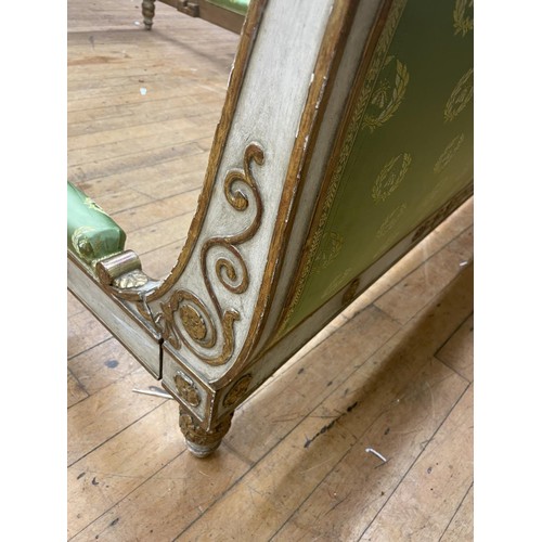 994 - A late 19th/early 20th century French painted double day bed frame, highlighted in gilt, 143 cm wide