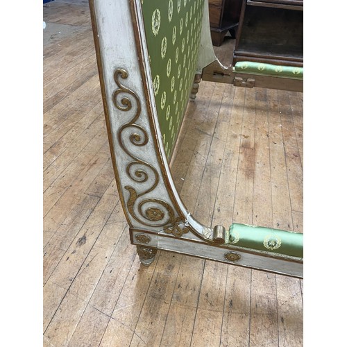 994 - A late 19th/early 20th century French painted double day bed frame, highlighted in gilt, 143 cm wide