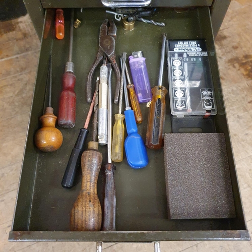 548 - Assorted tools and other items, in a painted metal filing cabinet, 29 cm wide