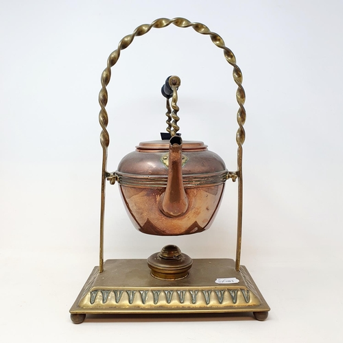 107 - An early 20th century brass and copper kettle, on a stand, 42 cm high