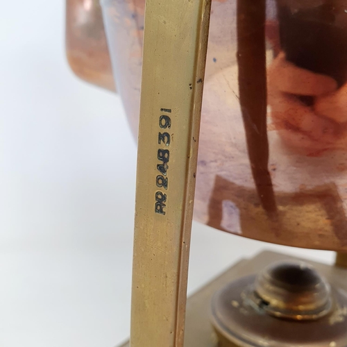 107 - An early 20th century brass and copper kettle, on a stand, 42 cm high