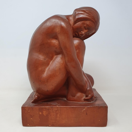 60 - An Art Deco style terracotta figure, of a kneeling woman, 32 cm high