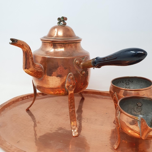 65 - A Scandinavian copper tea set, comprising a kettle, milk jug, sugar bowl and an oval tray, 45 cm wid... 