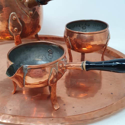 65 - A Scandinavian copper tea set, comprising a kettle, milk jug, sugar bowl and an oval tray, 45 cm wid... 