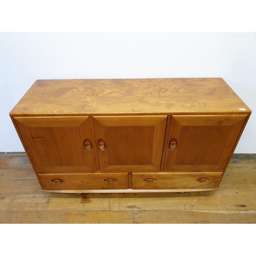 8 - An Ercol light elm sideboard, having three cupboard doors and two drawers, on castors, 132 cm wide