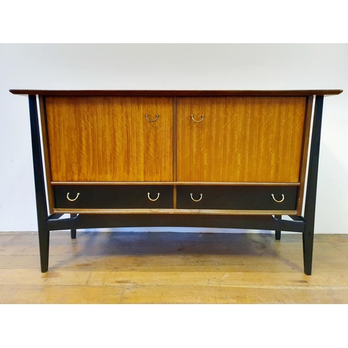 9 - A 1960s G-Plan dining room suite, comprising a sideboard, 133 cm wide, a dining table and four chair... 