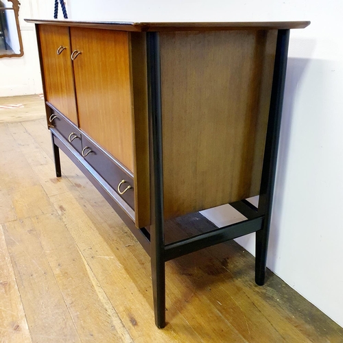 9 - A 1960s G-Plan dining room suite, comprising a sideboard, 133 cm wide, a dining table and four chair... 