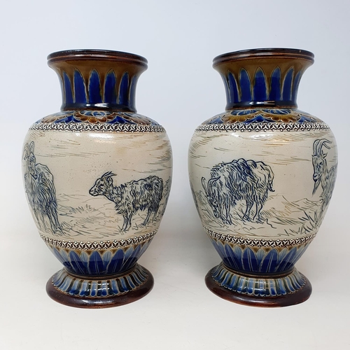 97 - A pair of Doulton Lambeth vases, by Hannah Barlow, decorated goats, 26 cm high