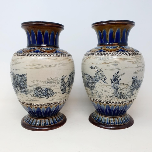 97 - A pair of Doulton Lambeth vases, by Hannah Barlow, decorated goats, 26 cm high