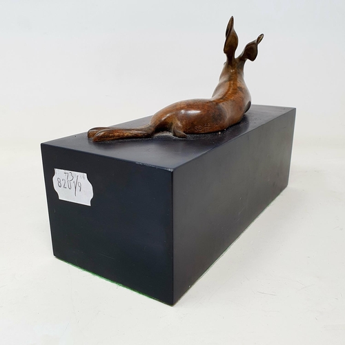 99 - A bronze figure of a rabbit, on a slate base, 22 cm wide