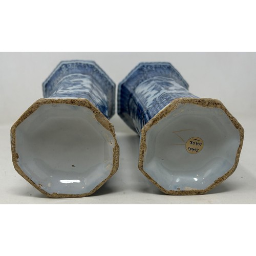 734 - A pair of blue and white Delft vases, decorated in the Chinese manner, 25 cm high