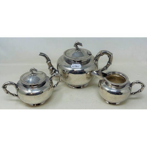 740 - A Chinese silver coloured metal three piece tea set, monogrammed, with hammered style decoration and... 