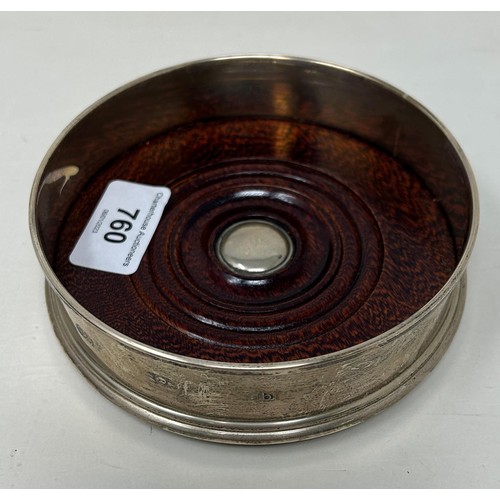 760 - A modern silver bottle coaster, with a mahogany base, 13 cm diameter