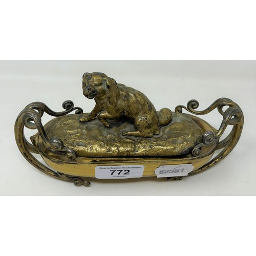 772 - A gilt metal inkstand, with a dog finial, 20 cm wide