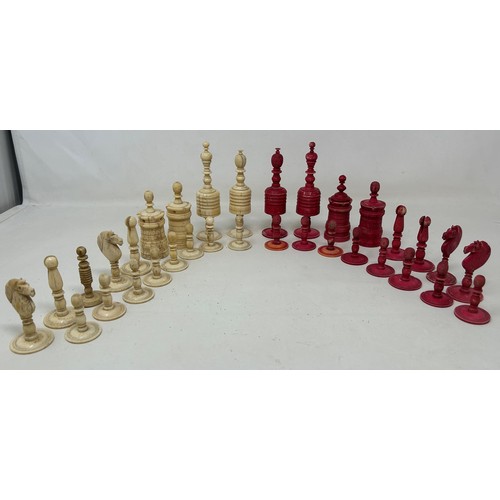 774 - A red stained and natural bone chess set, the king 11 cm high, and a black and natural wood chess se... 