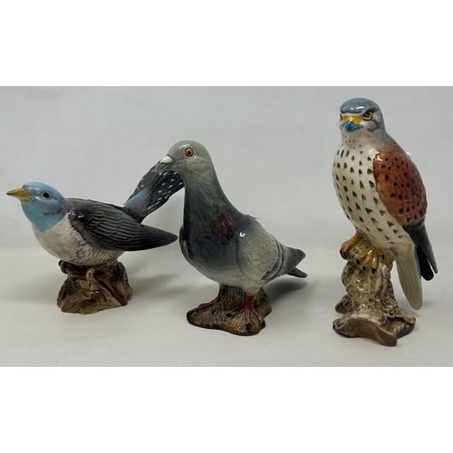 792 - A Beswick pigeon, 15 cm high, two other Beswick birds, and a Continental parrot (4)