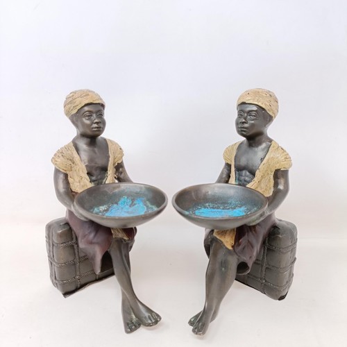 606 - A pair of cold painted bronze salts, in the form of eastern boys, 20 cm high (2)