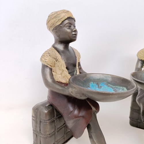 606 - A pair of cold painted bronze salts, in the form of eastern boys, 20 cm high (2)