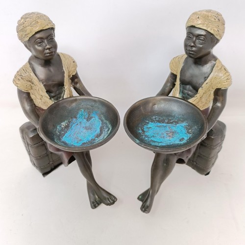 606 - A pair of cold painted bronze salts, in the form of eastern boys, 20 cm high (2)