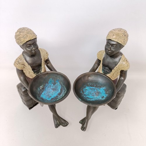 606 - A pair of cold painted bronze salts, in the form of eastern boys, 20 cm high (2)