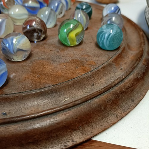 613 - A solitaire board, with marbles, 40 cm diameter