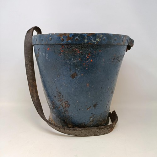 620 - A 19th century leather fire bucket, a cast metal door stop in the form of Mr Punch, a papier mache t... 