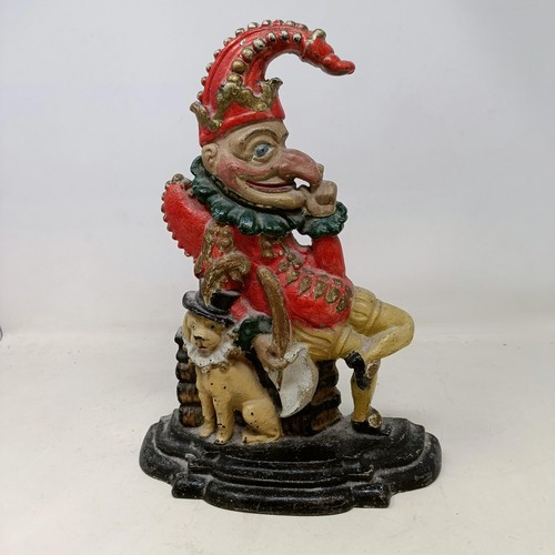 620 - A 19th century leather fire bucket, a cast metal door stop in the form of Mr Punch, a papier mache t... 