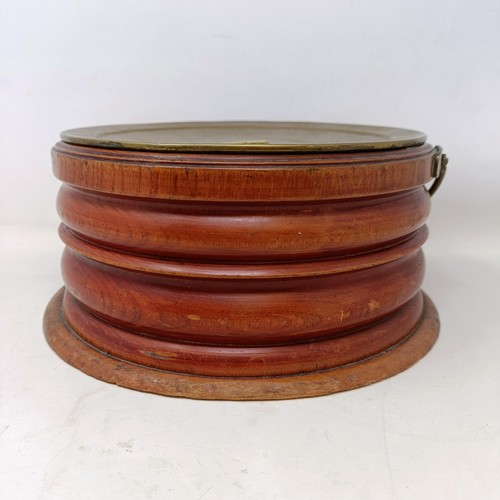 657 - A 19th century mahogany and brass foot warmer, with a ring handle, 28 cm diameter