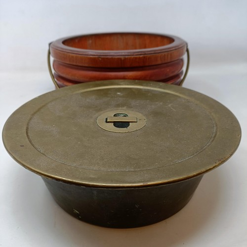 657 - A 19th century mahogany and brass foot warmer, with a ring handle, 28 cm diameter