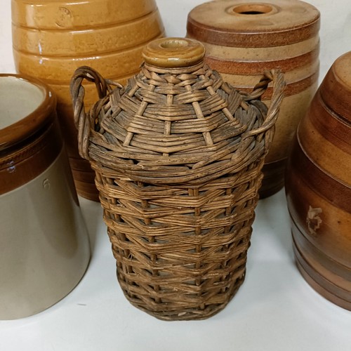 686 - A Doulton Lambeth stoneware barrel, 31 cm high, two other barrels, a storage jar, and a wicker cover... 