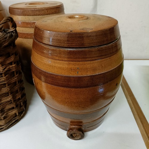 686 - A Doulton Lambeth stoneware barrel, 31 cm high, two other barrels, a storage jar, and a wicker cover... 