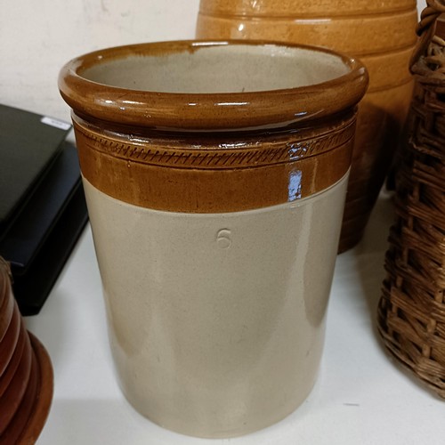 686 - A Doulton Lambeth stoneware barrel, 31 cm high, two other barrels, a storage jar, and a wicker cover... 