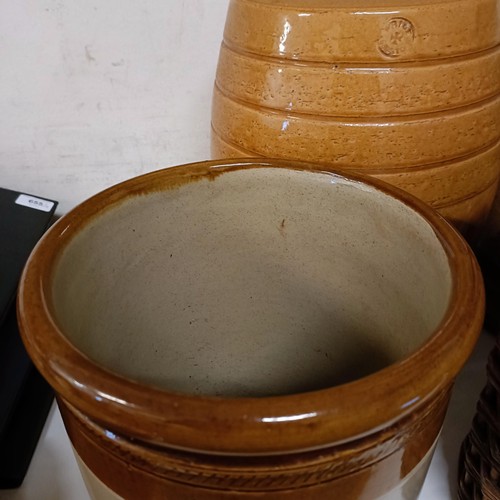 686 - A Doulton Lambeth stoneware barrel, 31 cm high, two other barrels, a storage jar, and a wicker cover... 