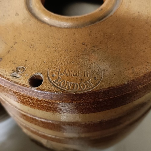 686 - A Doulton Lambeth stoneware barrel, 31 cm high, two other barrels, a storage jar, and a wicker cover... 