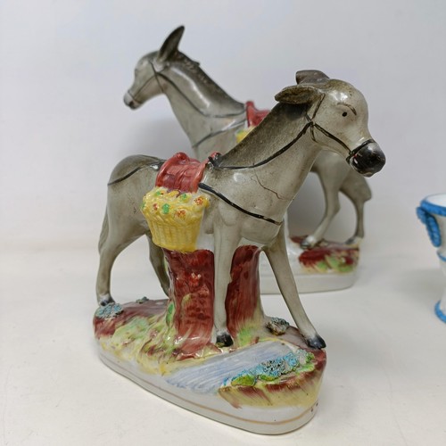 701 - A 19th century Staffordshire figure, of a donkey, 23 cm high, another, 16 cm high, a cow, a figural ... 