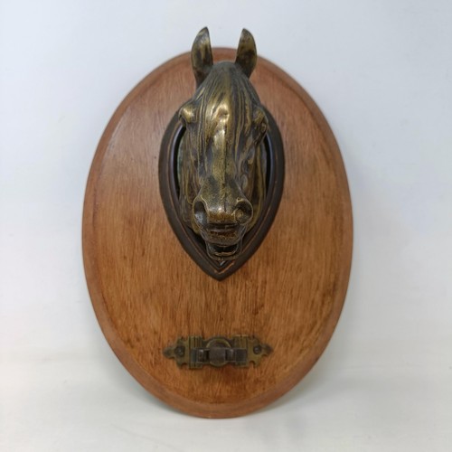 710 - A brass and stained wood wall mounted crop stand, in the form of a horse, 36 cm