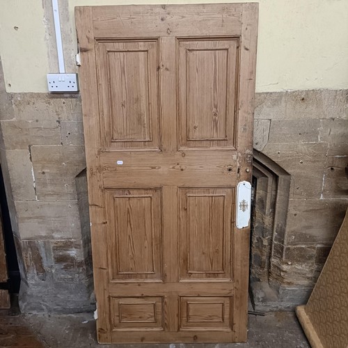 974 - An oak door, 176 x 82 cm, and two other doors (3)